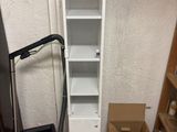 a box and a vacuum in the corner of a room