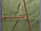 a green bag with a zipper on it on a table
