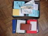 a suitcase filled with books and papers on the floor