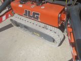 a small orange machine that is sitting on the ground