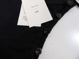 the back of a pair of black pants with a tag on it