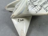 a white origami shaped object with writing on it
