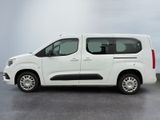 the white van is parked on the concrete floor in the room