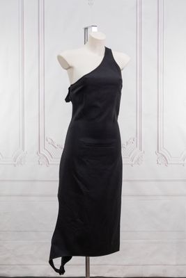 the dress is black and has a one shoulder design