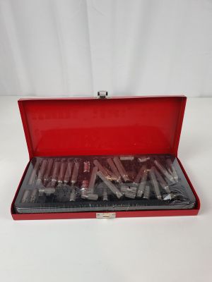 an open red case with a bunch of tools inside of it
