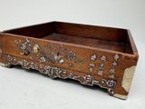 a small wooden box with a design on it