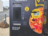a vending machine that has a pizza on it