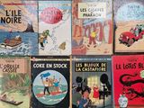 several children ' s books are lined up on a table
