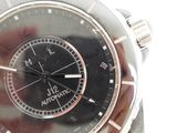 a close up of a wrist watch with a black face