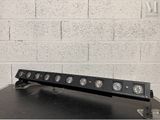 a close up of a light bar on a table with a brick wall in the background