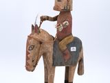 an image of a wooden statue of a man on a horse