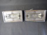 pair of silver metal wall lights on a black surface