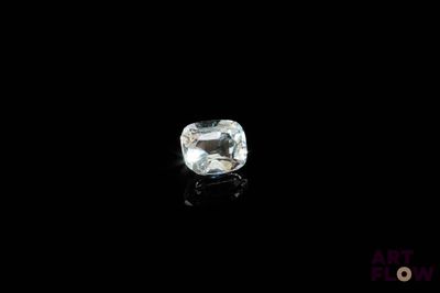 a close up of a white diamond on a black surface