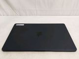 a black apple laptop sitting on a white surface