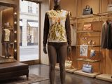 a mannequin in a clothing store with a lot of mannequins
