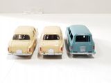three toy cars sitting next to each other on a white surface