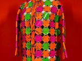 a close up of a mannequin torso with a colorful shirt on it