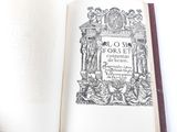 an open book with a picture of a statue on it