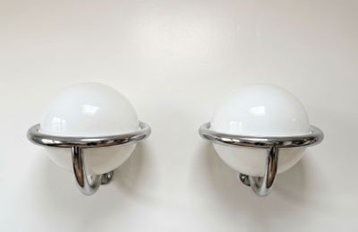 pair of chrome and glass sconces on a white wall
