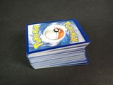 a stack of pokemon cards sitting on a table