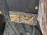 a close up of a black jacket with a gold design