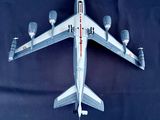 an overhead view of a model airplane on a black background
