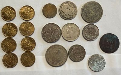 some coins are sitting on a table with a white table cloth