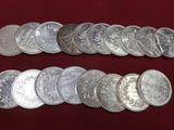 a close up of a bunch of silver coins on a red surface