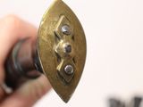 a close up of a person holding a metal object