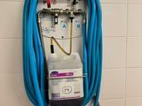 a blue hose attached to a wall in a bathroom