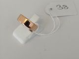 a close up of a ring on a white surface with a price tag
