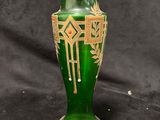 a green vase sitting on a black background