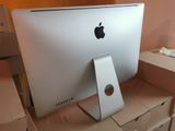 a white apple computer sitting on top of a cardboard box