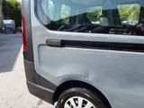 a small grey van parked on the side of the road