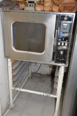 a small oven with bread on top of it