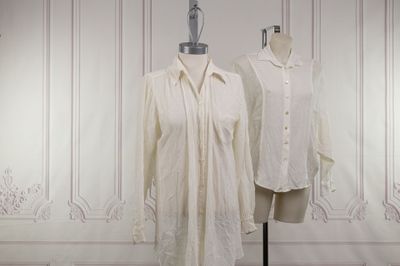 deux chemises blanches posées sur un mannequin se trouvent devant un mur blanc
