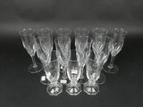 six clear wine glasses sitting on top of a black table