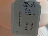 a white vase with a tag on it that says jesus 32