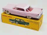 a pink toy car sitting on top of a yellow box