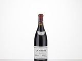 a bottle of red wine sitting on top of a table