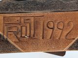 a close up of a metal object with writing on it