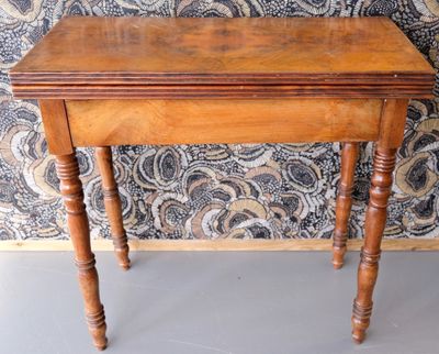 a small wooden table with a wooden top on a gray floor
