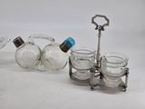a glass bottle and a metal holder with glass jars on it