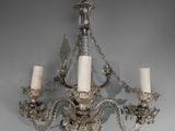 a chandelier with three candles hanging from it