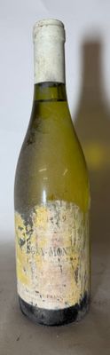 a bottle of wine sitting on a table next to a bottle of wine