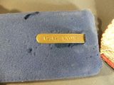 a gold plate on a blue cloth next to a red and white cloth