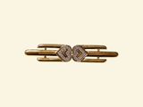 a close up of a gold and diamond hair clip