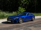 the blue mercedes sports car is parked on the side of the road