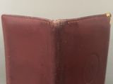 an image of a brown leather wallet with a coin in it
