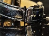 a black leather watch with a silver buckle on it